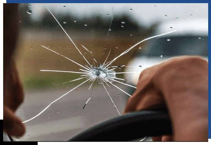 A person is holding the steering wheel of their car.